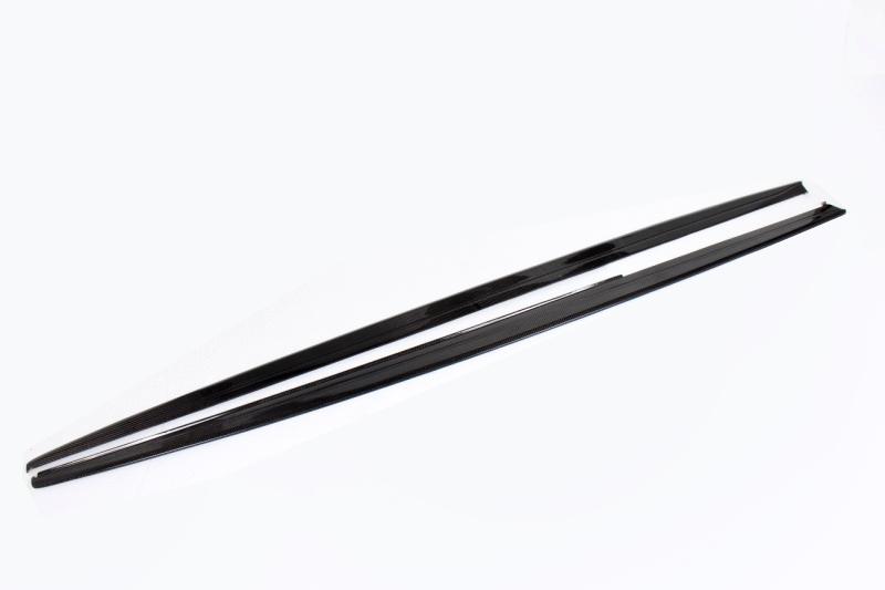 A pair of carbon fiber side skirts for BMW F30 designed to complement the vehicle's aesthetics and improve aerodynamics.