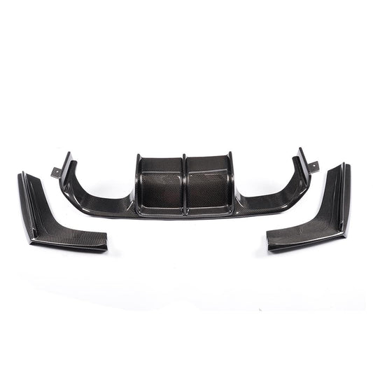 A carbon fiber rear diffuser for BMW F80 and F82 models, featuring a v-shaped design for airflow optimization and a high-gloss finish.