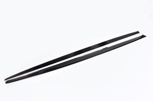 A pair of carbon fiber side skirts for BMW F30 designed to complement the vehicle's aesthetics and improve aerodynamics.