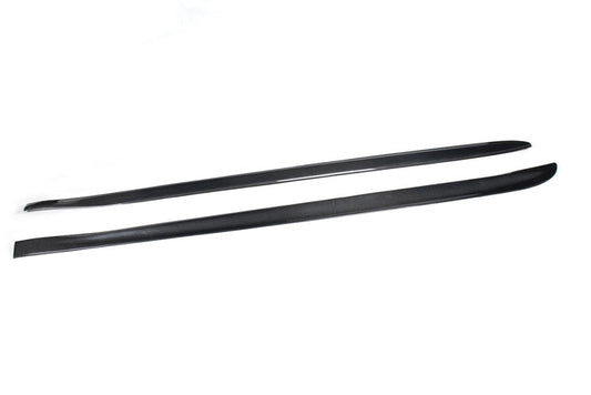 A pair of carbon fiber side skirts designed for the BMW F32, presented on a white background.