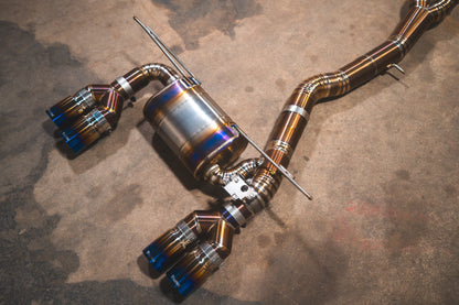 Angled view of the titanium Valvetronic BMW F8x M3 / M4 Equal Length Valved Sport Exhaust System | Insignist Motorsports
