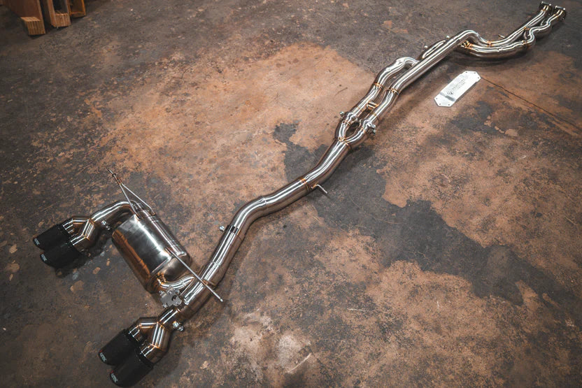 Angled view of the Valvetronic BMW F8x M3 / M4 Equal Length Valved Sport Exhaust System | Insignist Motorsports in steel 