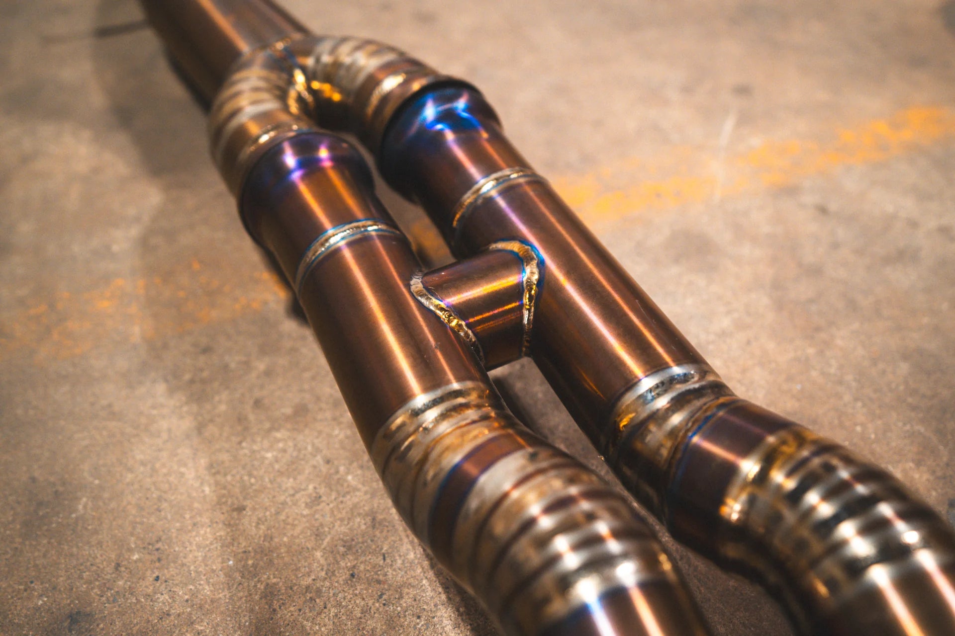 Closeup of the Y pipe on the Valvetronic BMW F8x M3 / M4 Equal Length Valved Sport Exhaust System | Insignist Motorsports in titanium 