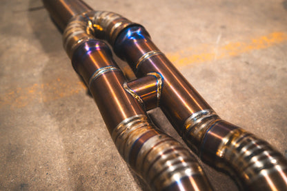 Closeup of the Y pipe on the Valvetronic BMW F8x M3 / M4 Equal Length Valved Sport Exhaust System | Insignist Motorsports in titanium 
