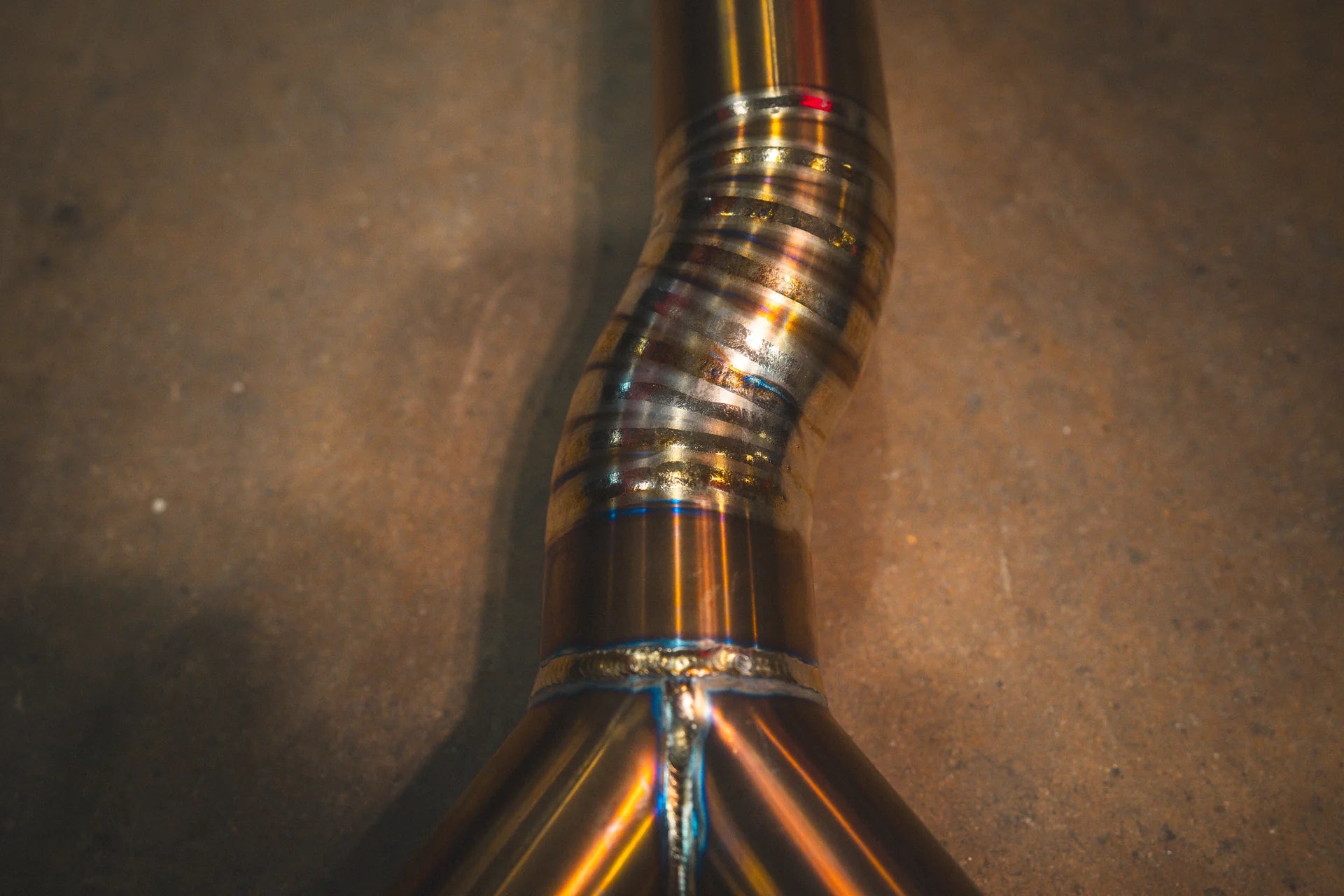Closeup on the S pipe in titanium for the Valvetronic BMW G8x M3 / M4 Valved Sport Exhaust System | Insignist Motorsports