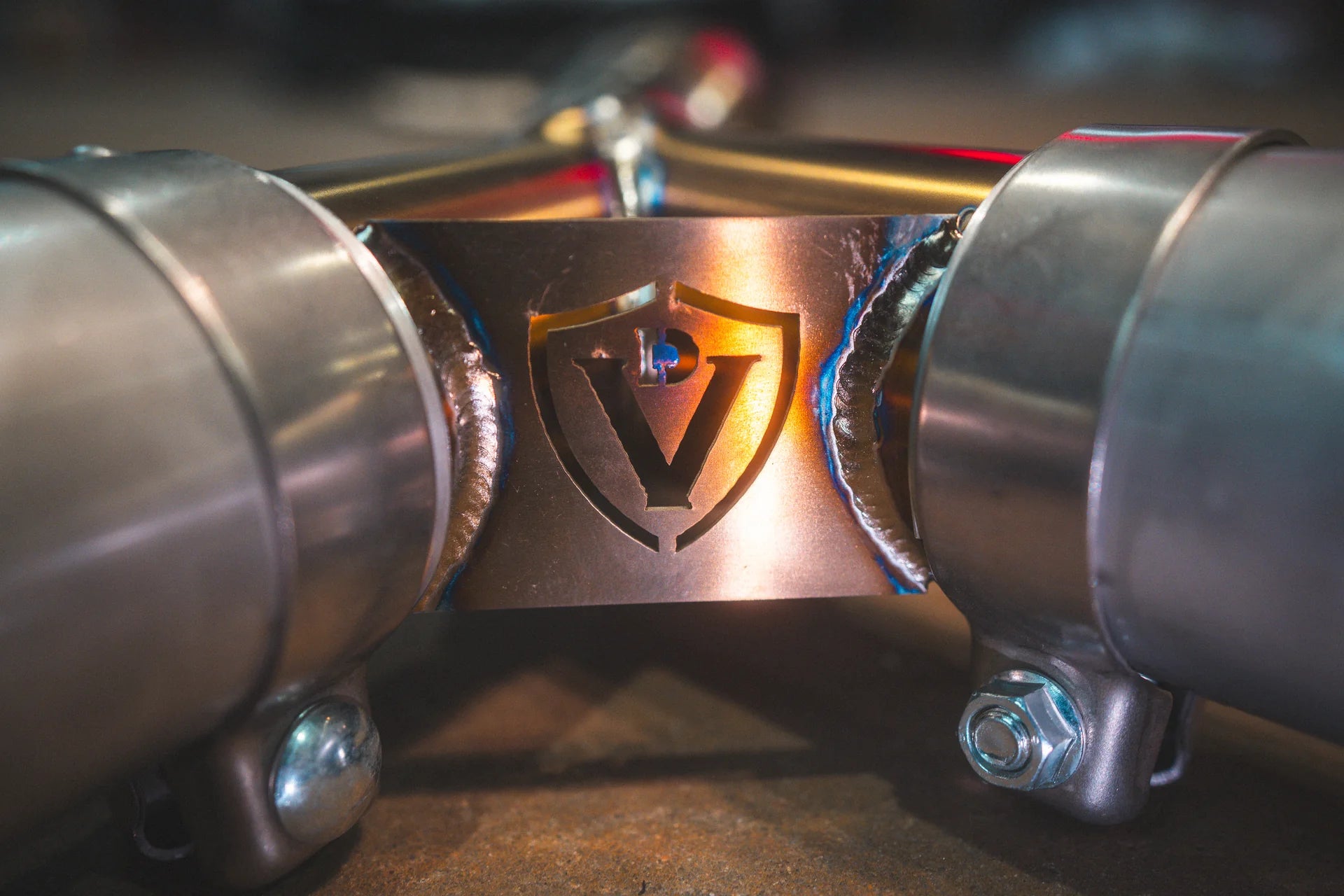 Closeup for the titanium logo on the Valvetronic BMW G8x M3 / M4 Valved Sport Exhaust System | Insignist Motorsports