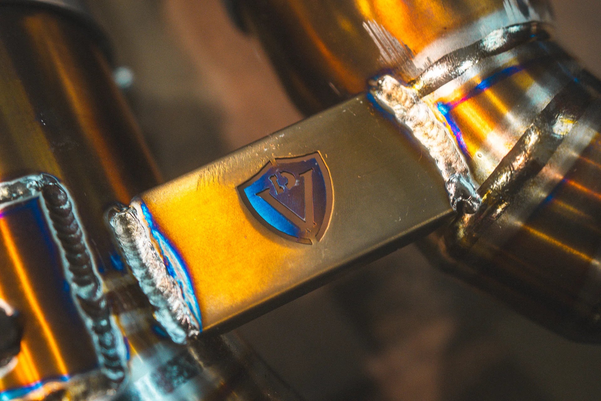 Closeup on the titanium label for the Valvetronic BMW G8x M3 / M4 Valved Sport Exhaust System | Insignist Motorsports