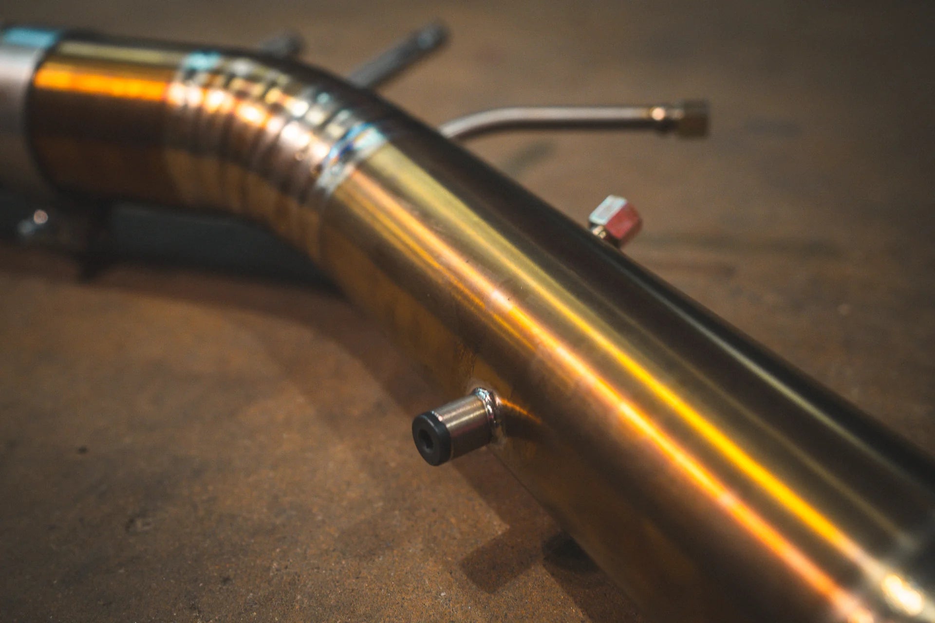 Closeup of the pipe for the titanium Valvetronic BMW G8x M3 / M4 Valved Sport Exhaust System | Insignist Motorsports