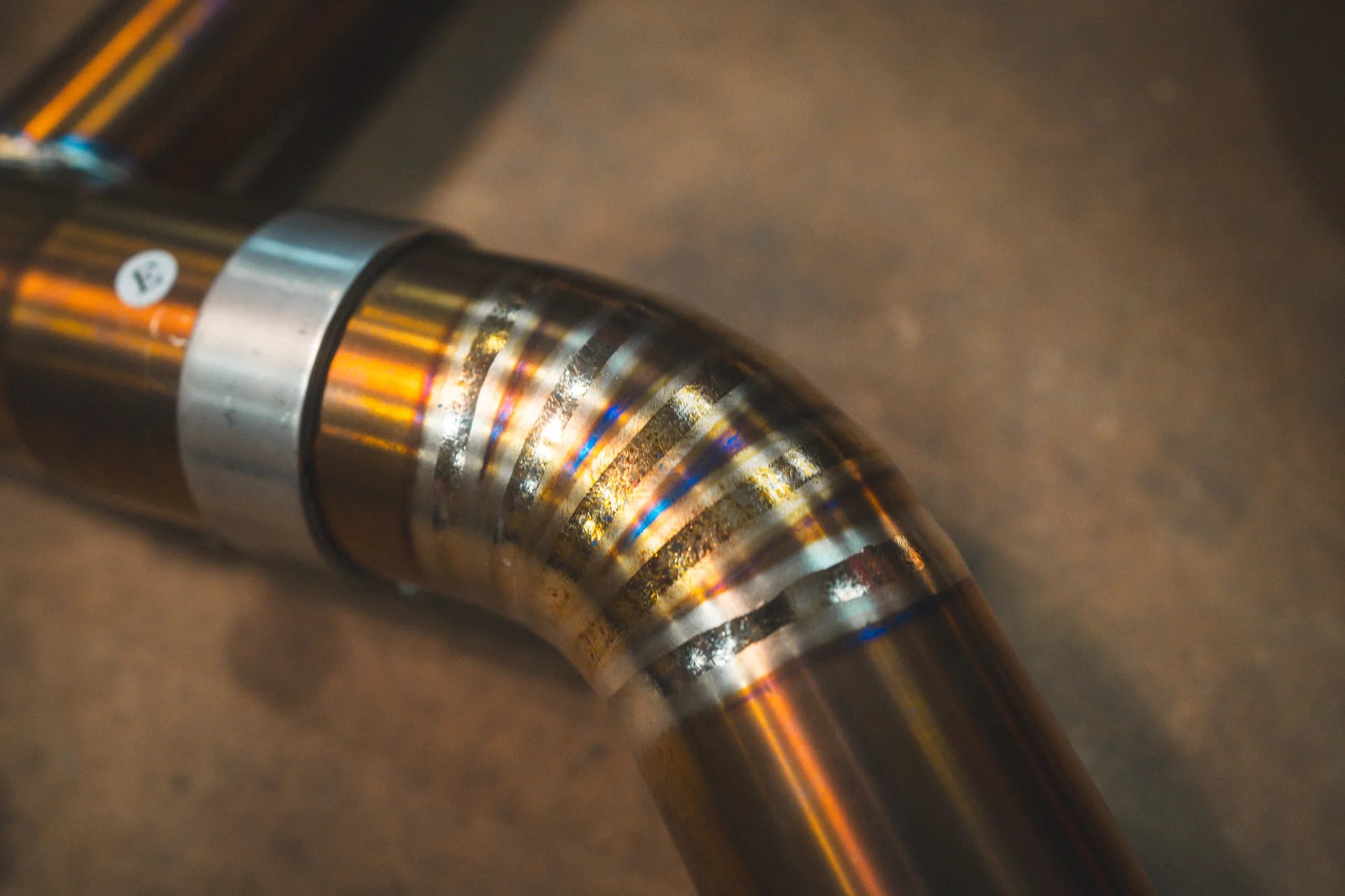 Closeup of the titanium pipe on the Valvetronic BMW G8x M3 / M4 Valved Sport Exhaust System | Insignist Motorsports