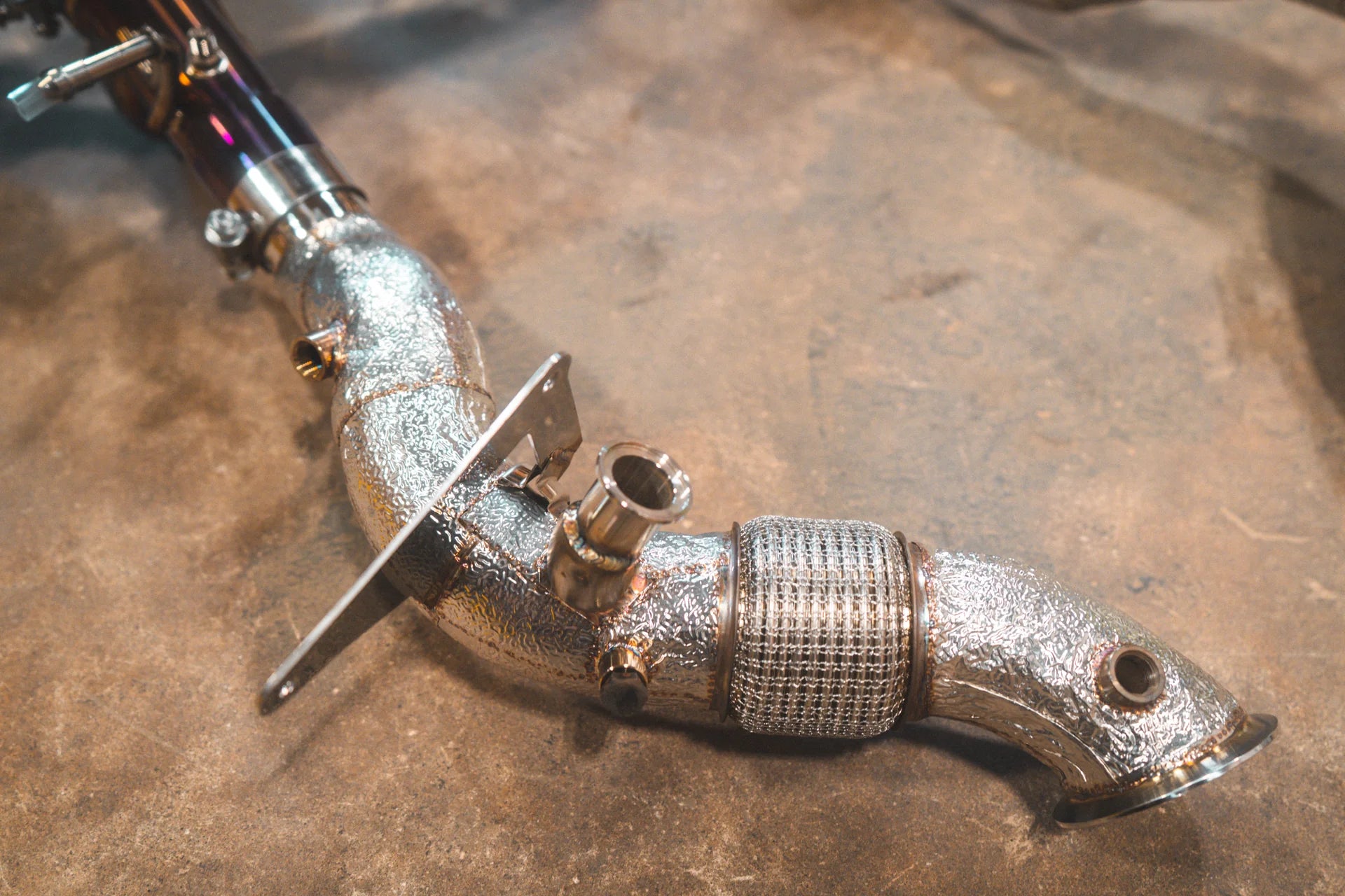 One end of the Valvetronic Ferrari F8 Valved Sport Exhaust System