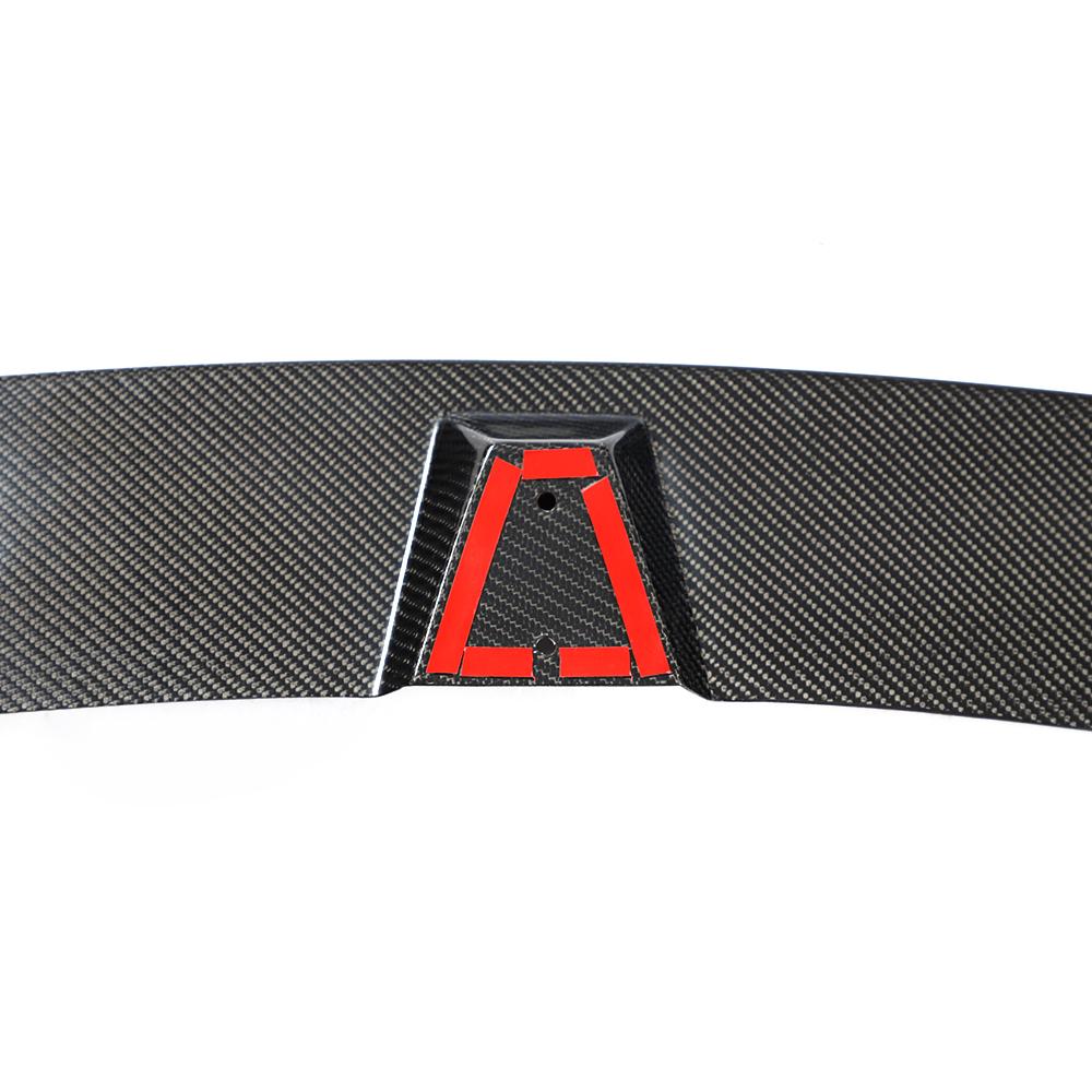 A carbon fiber front lip designed for BMW F32, featuring a black weave pattern with red accents along the lower edge.