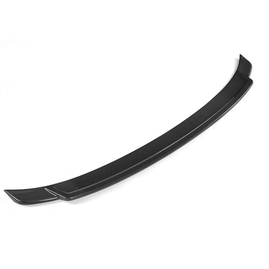An exotic black carbon fiber trunk spoiler designed for a BMW F32.