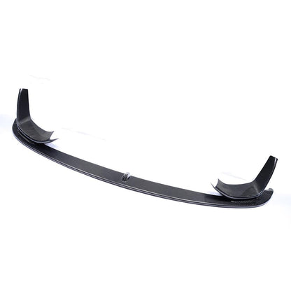 A black carbon fiber front lip designed for BMW F80 and F82 models.