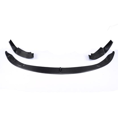 A black carbon fiber front lip designed for BMW F80 and F82 models.